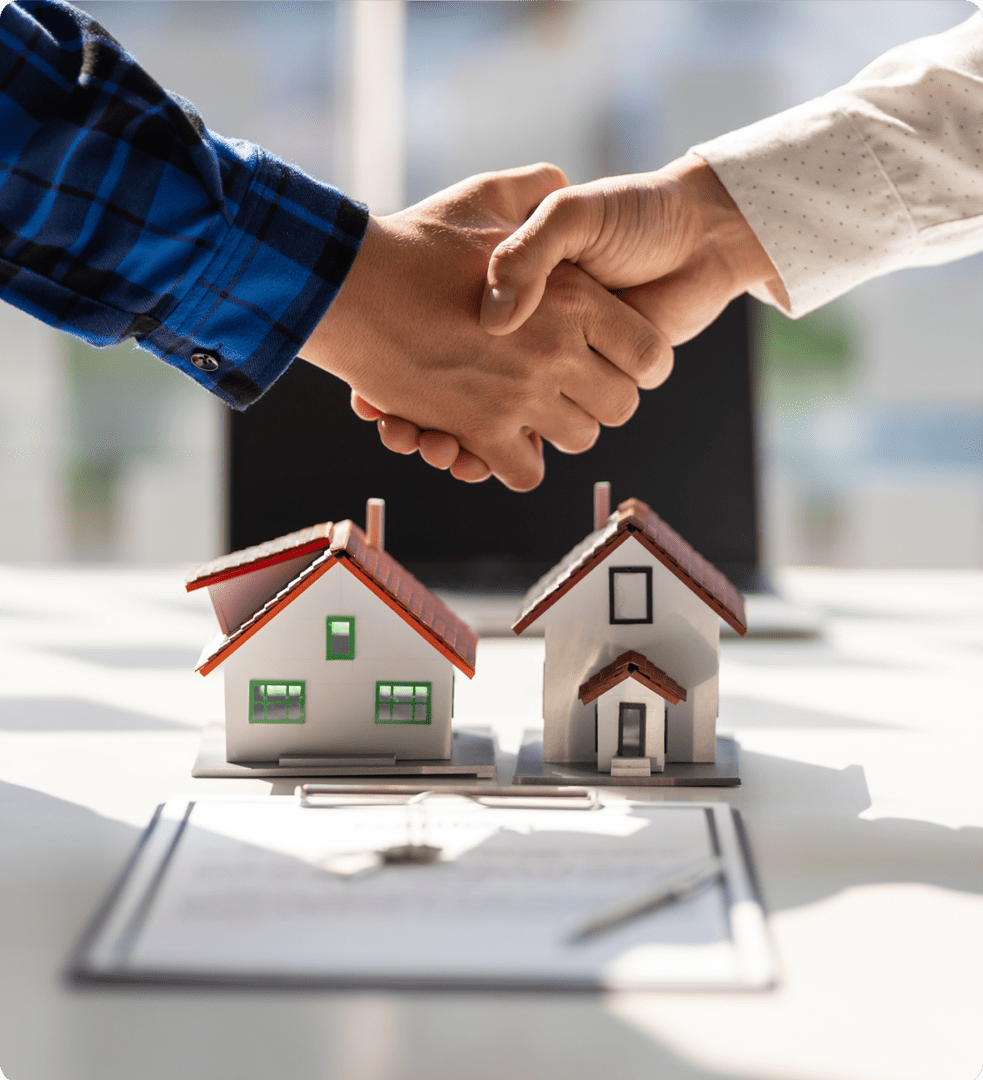 Real estate deal with handshake and models