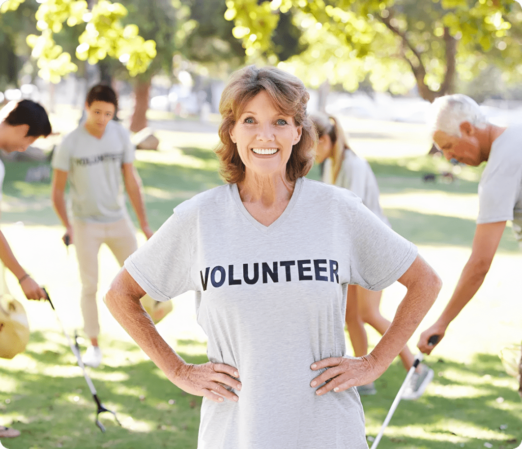 Happy volunteer team cleaning up park